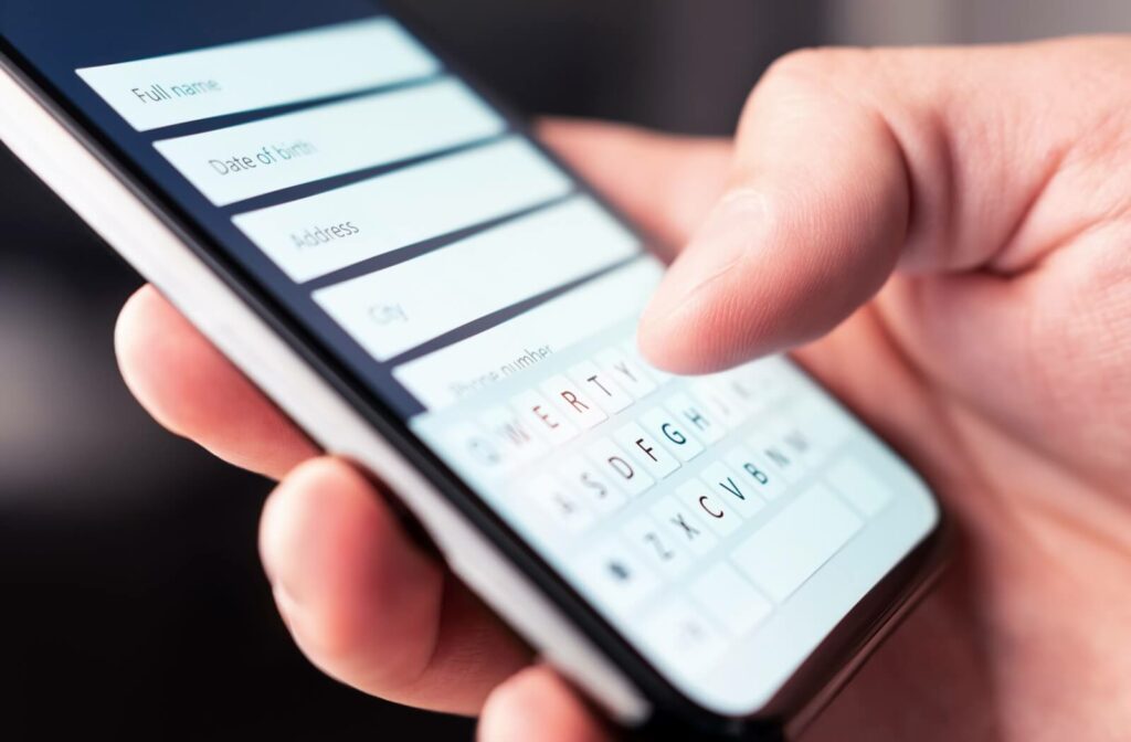 Close-up of a person's smartphone as they fill out an online form